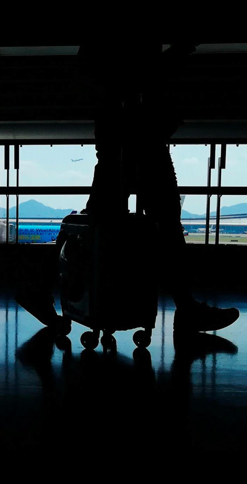 Travelers walking through an airport terminal