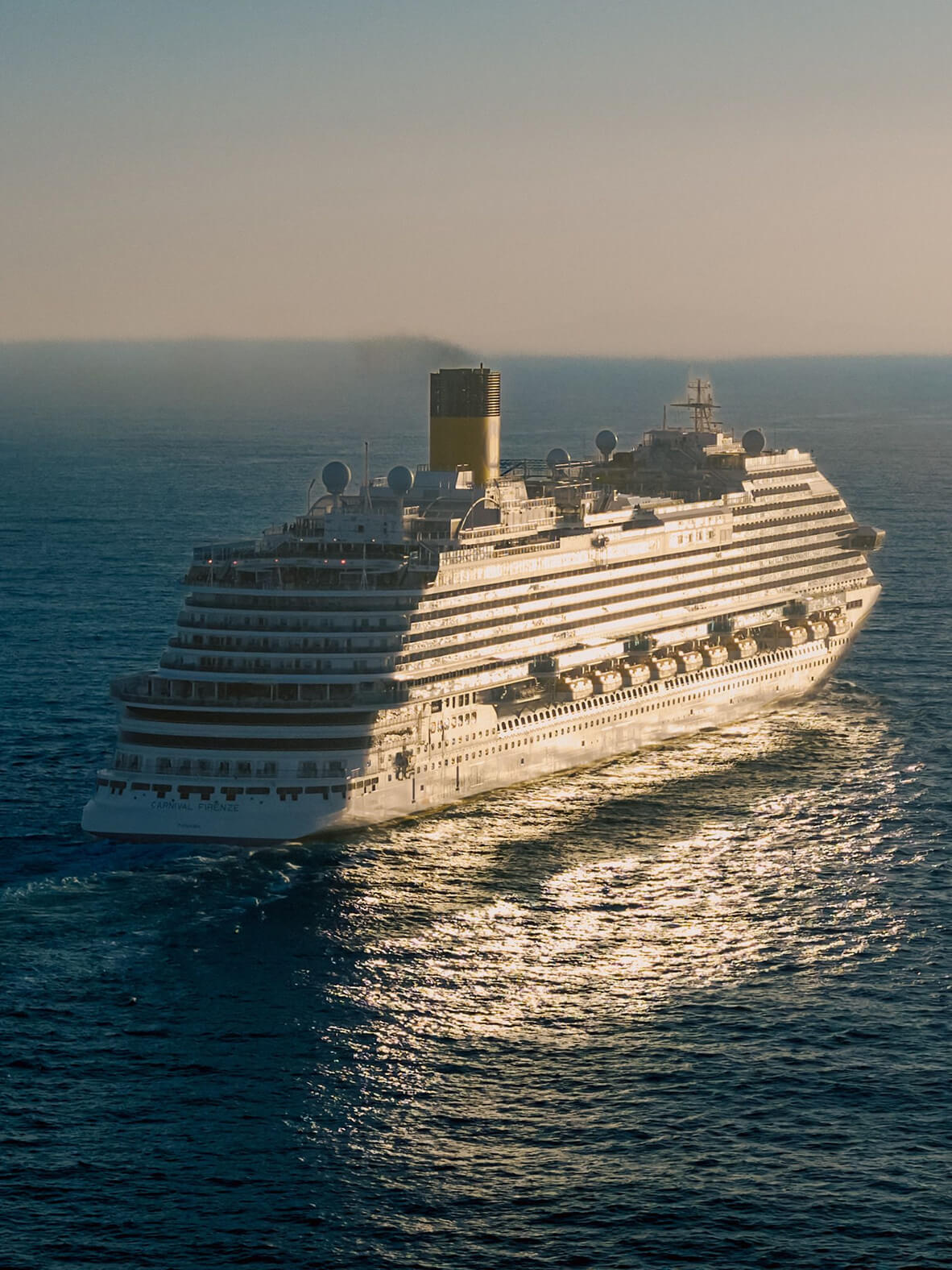 Cruise ship sailing at sunset