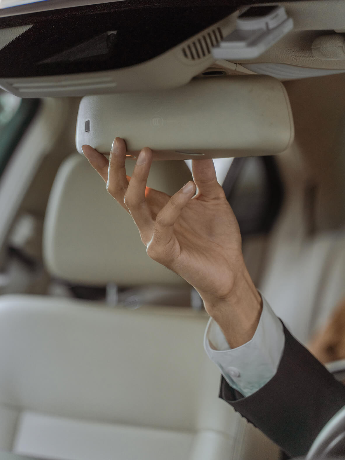 Passenger in the back seat of a luxury car